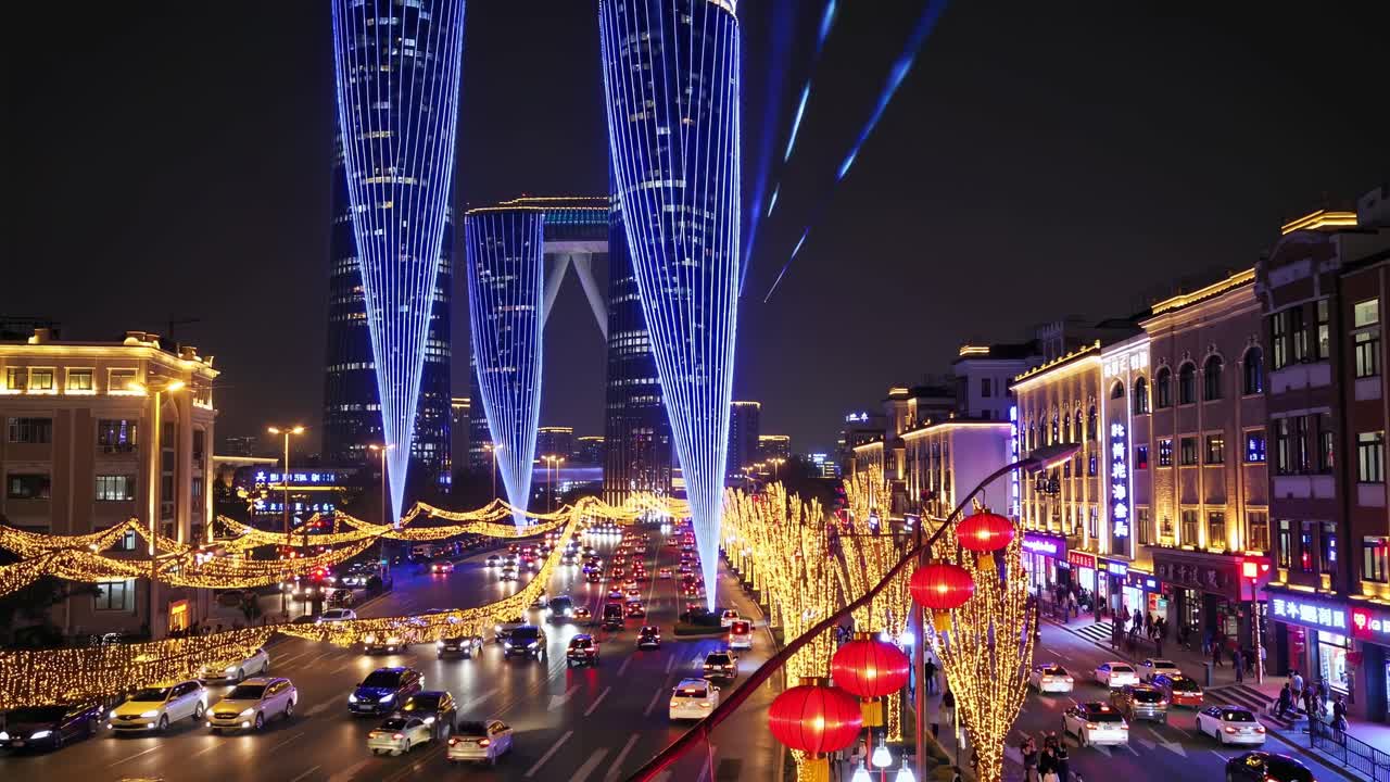 Illuminated Gate of the Orient skyscrapers towering over busy Tianjin street at night, decorated with festive lights and bustling traffic, creating a vibrant urban scene