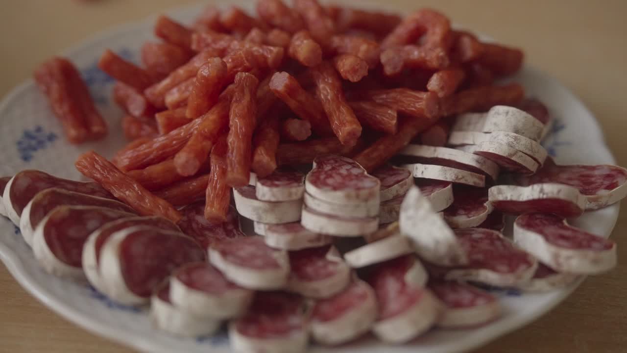 Sausages arranged on a plate. Meat delicacies prepared at home in the kitchen. Close up shot