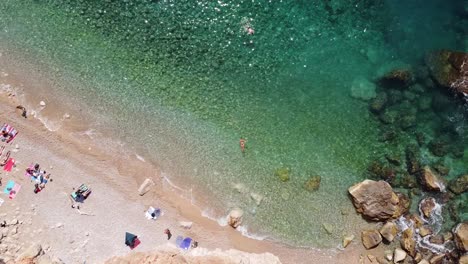 hidden sandy pasjaca beach in dalmatia, croatia - aerial top down ascending