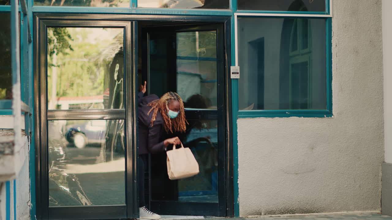 Delivery person entering building