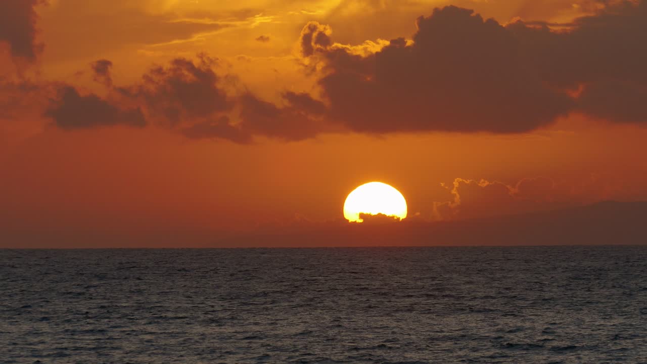 극적인 구름과 함께 바다 위에 해가 지는 것