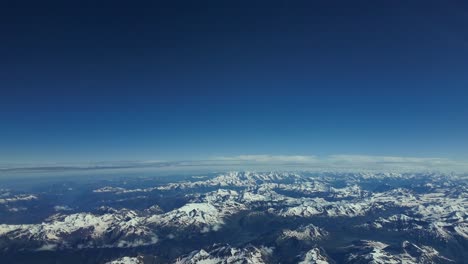 pov pilot pov of the alps range, shot from an airplane cabin