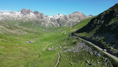 rv motorhome drive col de la croix de fer mountain pass in french alps - aerial follow