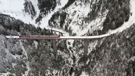 Überfliegen-Des-Viadukts-Mit-Einem-Vorbeifahrenden-Roten-Zug