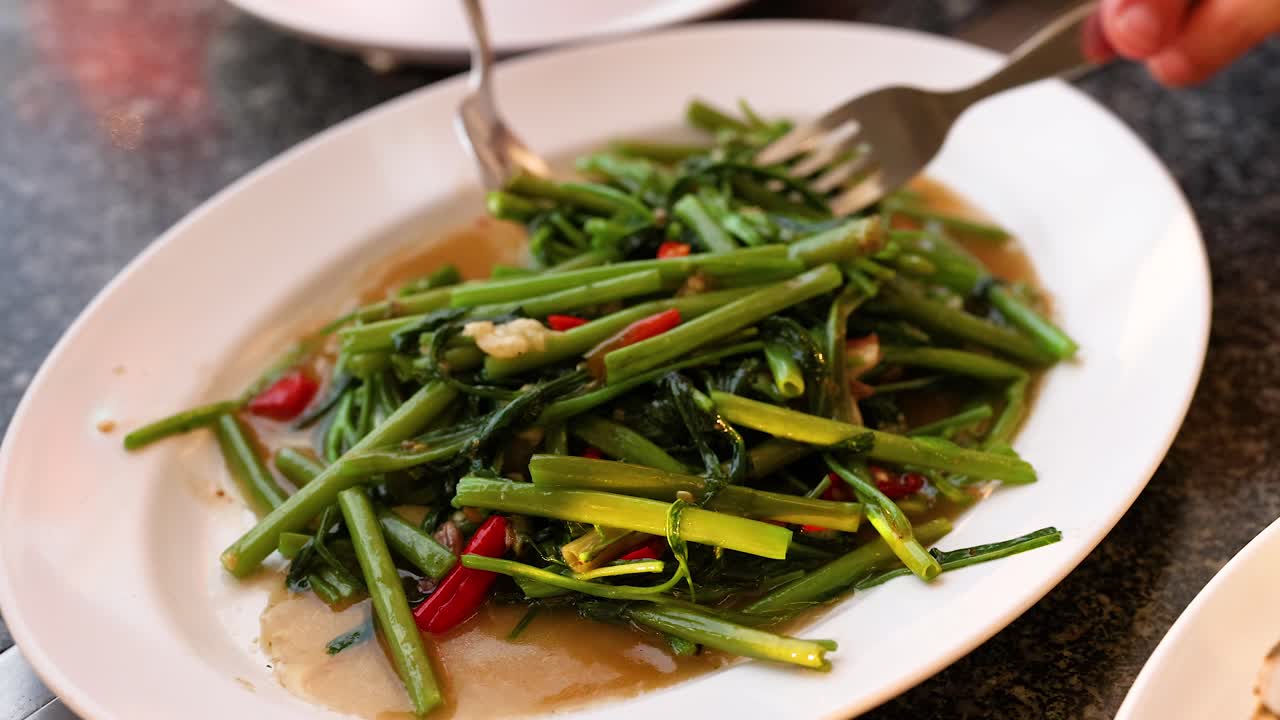 Delicious Thai stir-fried morning glory served