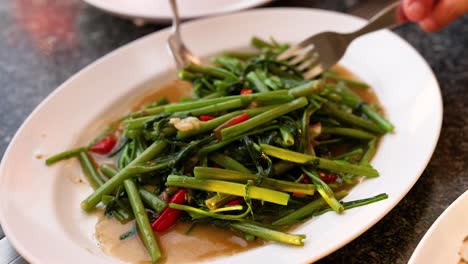 delicious thai stir-fried morning glory served