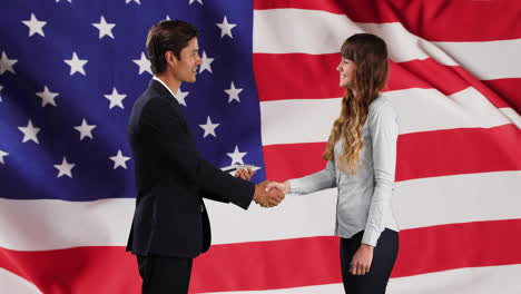 animation of flag of usa over happy caucasian businesspeople shaking hands