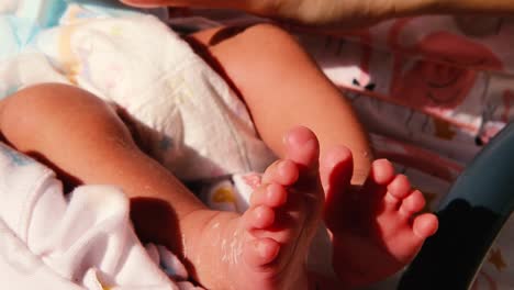 mother with new born baby foot after birth