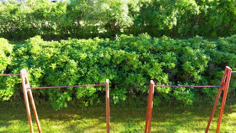 Old-rustic-outdoor-pull-up-bar-in-local-park-gym,-aerial-view-on-sunny-day