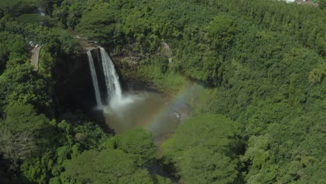 4k aerial pan over wailua falls with rainbow in kauai