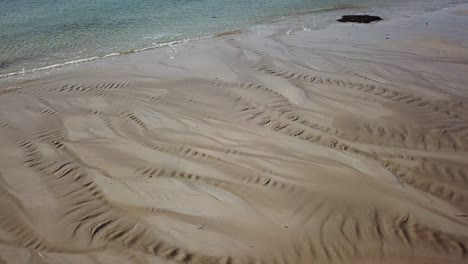 view of traces on the sand due to rivers flowing on an irish beach