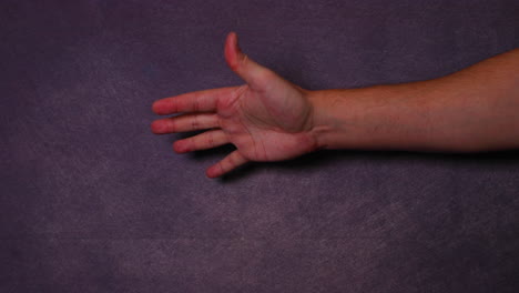 man's hand waving from side to side not good not bad gesture from left side on black background behind and front led light daylight all capture in 4k 60fps slow motion movement