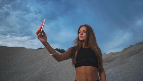 woman taking a selfie in a quarry landscape