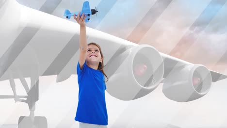 animation of happy caucasian girl playing with plane toy over plane