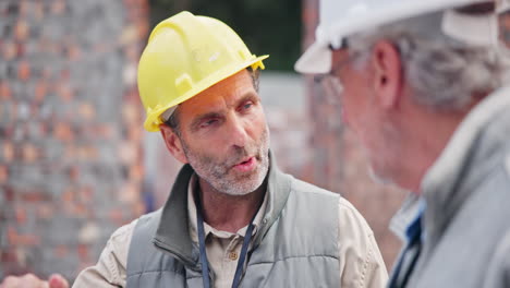 construction workers discussing plans at construction site