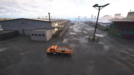 a dump truck parked in front of a warehouse and shipping containers