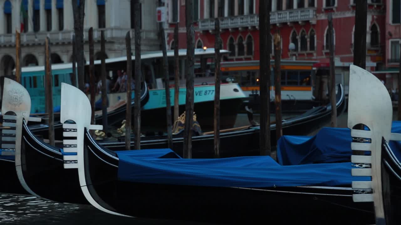 Venetian gondolas docking in a pier in Venice, Italy
