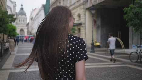 young woman walking in a city street