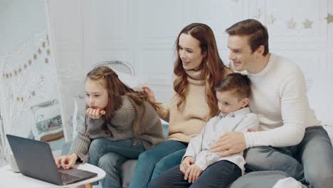 friendly family relaxing with notebook on christmas vacation.