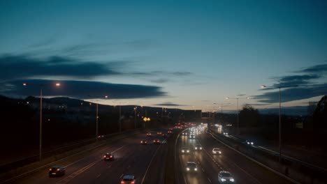 a locked-off shot of vehicles moving along the m50 motorway in dublin, ireland. the busy highway captures urban transportation and daily commuting, showing the movement of cars and trucks.