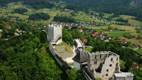 aerial view of ancient celje castle ruins on top of green hills in celje, slovenia