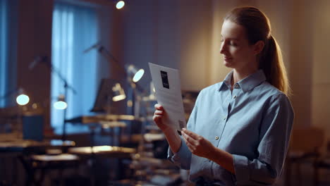 woman reading document in office