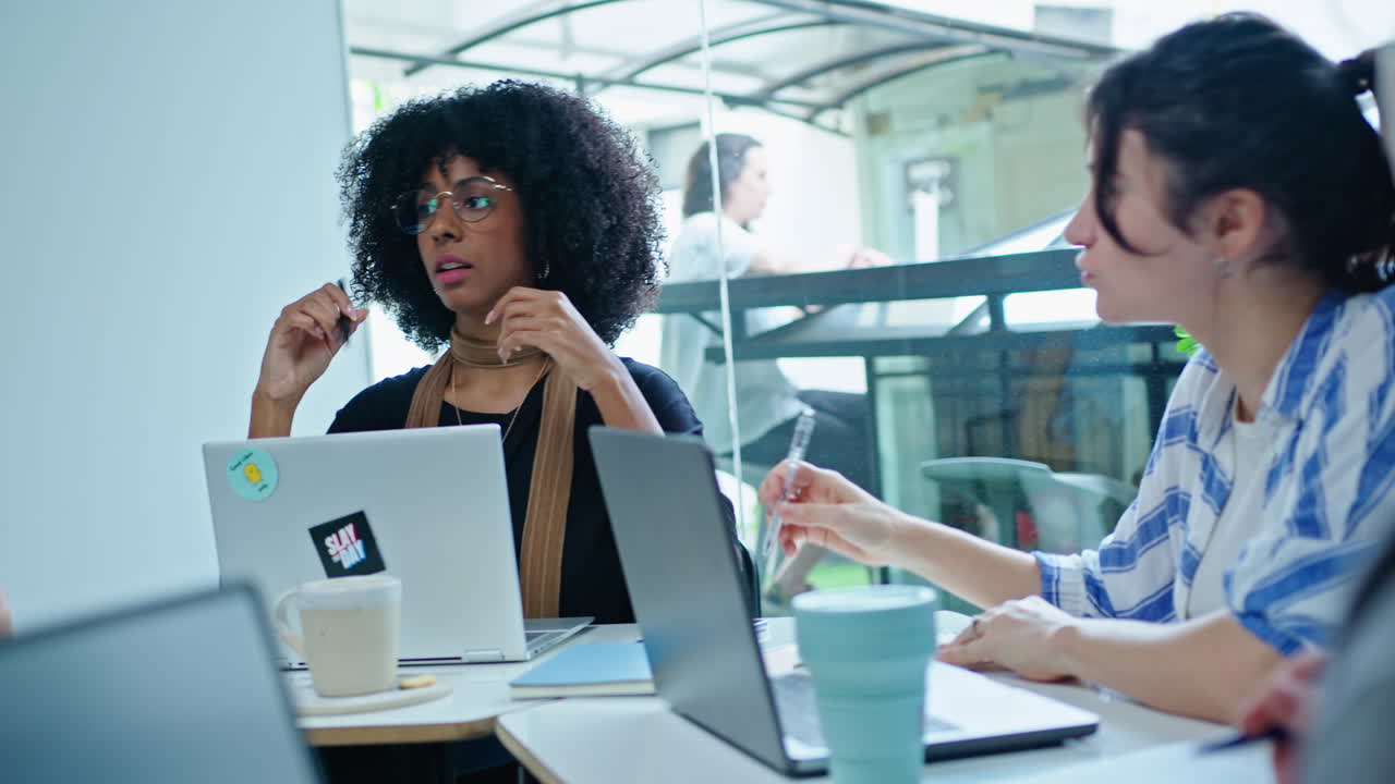Gen Z Man Sharing Business Ideas with Female Coworker on Meeting