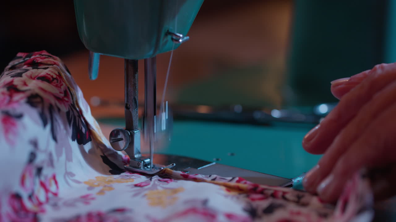 Close-up of a Vintage Sewing Machine Stitching Floral Fabric