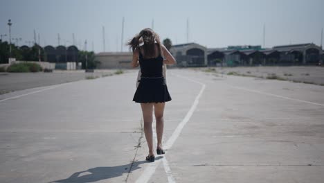 woman walking on an empty city road