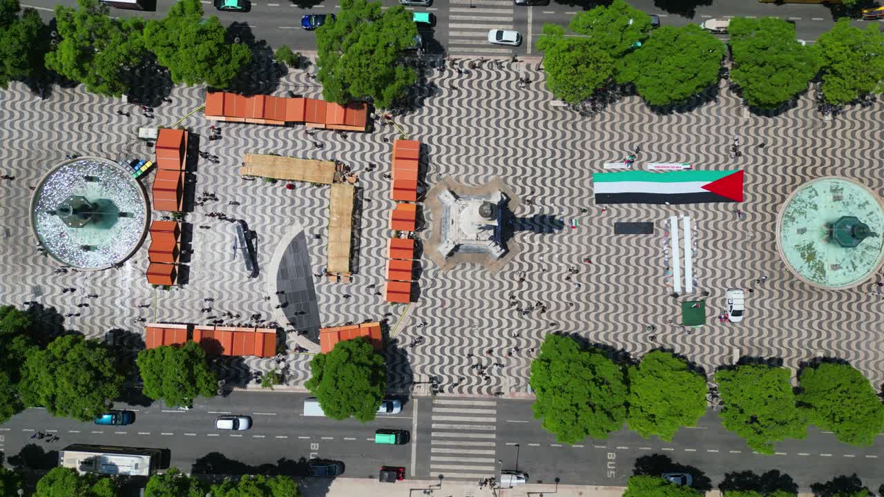 Aerial View of City Square with Flag and Crowd