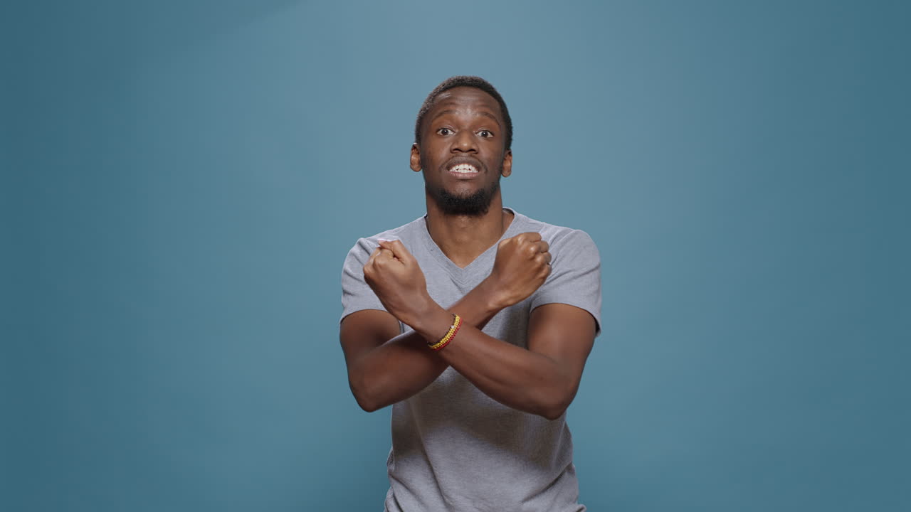 Displeased person showing disapproval and stop sign with arms