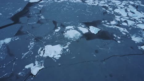 ice pieces floating in sea water on winter day