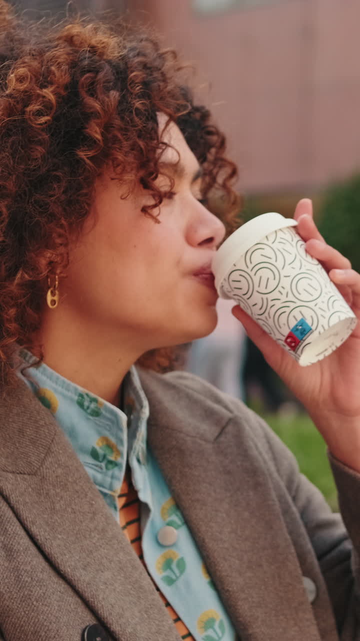 Woman Sipping Coffee in City Park