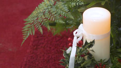 christmas candle lit, mistletoe, red background