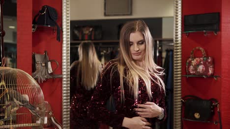 woman trying on a sequined dress in a boutique