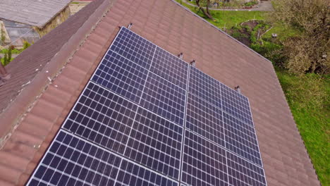 Rooftop-window-and-solar-panels,-aerial-drone-close-up-view