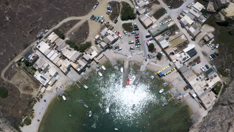 dwerja cave port town and rocky coastal landscape of malta,aerial tilt