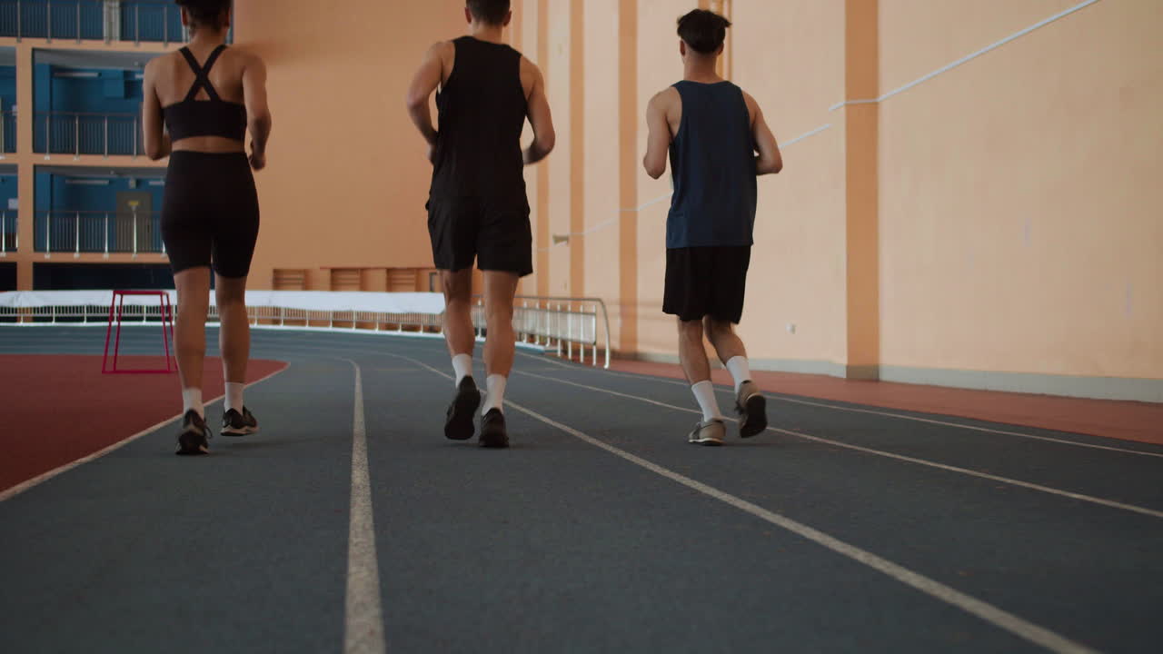 Back view of athletes running