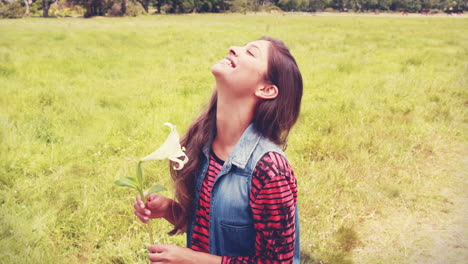 pretty brunette smelling a flower