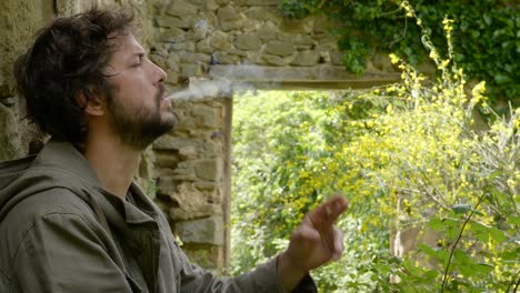 a hiker along the catalonia trails stops to enjoy the guilty pleasure of a cigarette