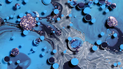 abstract art background of swirling blue and black colors, paint bubbles burst and react with glitter