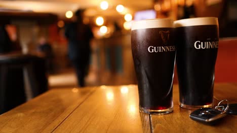 two pints of guinness on a table