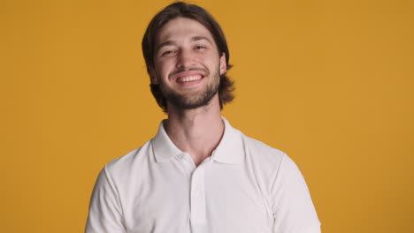 caucasian man making ok gesture on yellow background.