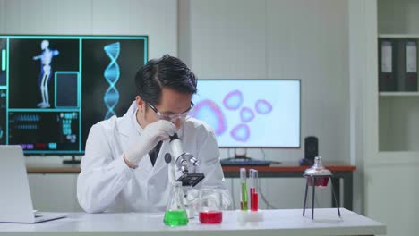 asian scientist researching in the laboratory with a microscope and speaking to the camera