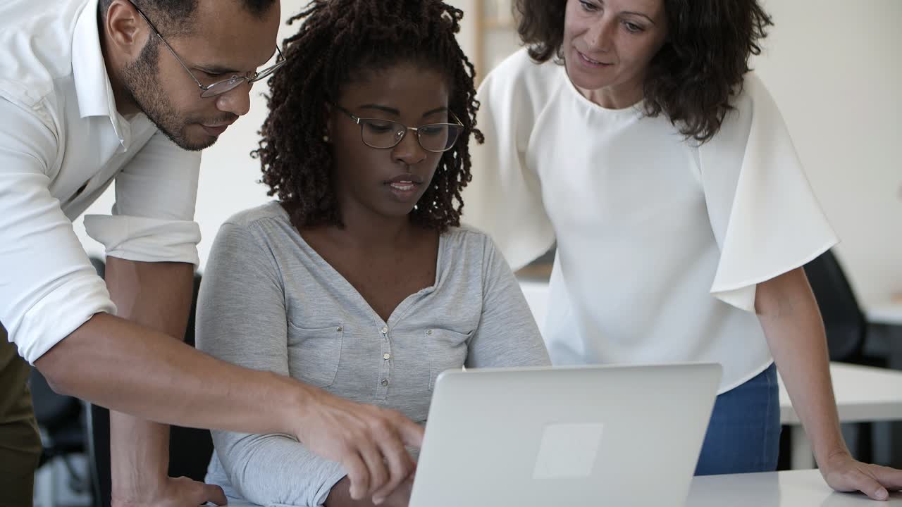 Front view of focused employees working in office