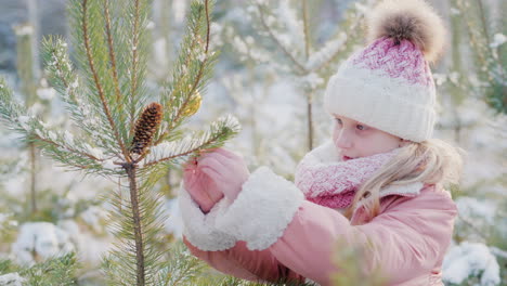 Una-Niña-Está-Decorando-Un-árbol-De-Navidad-En-Un-Patio-Cubierto-De-Nieve-Esperando-La-Navidad