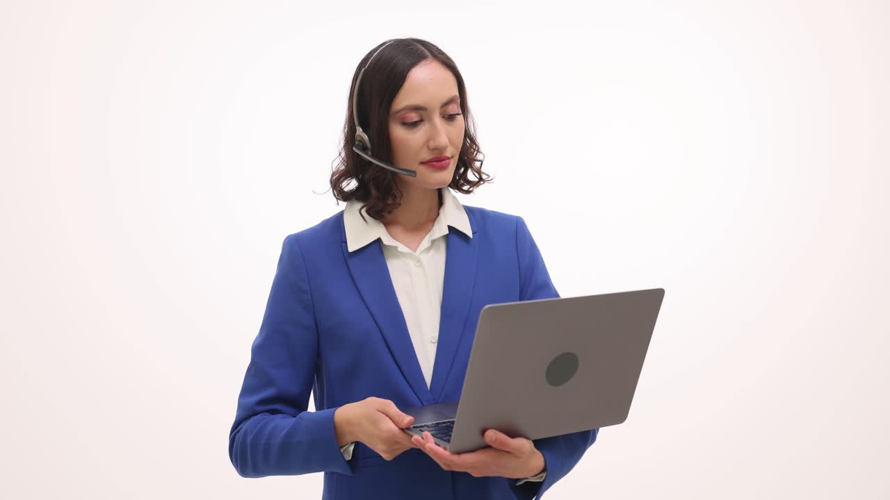 Businesswoman with headset holding laptop