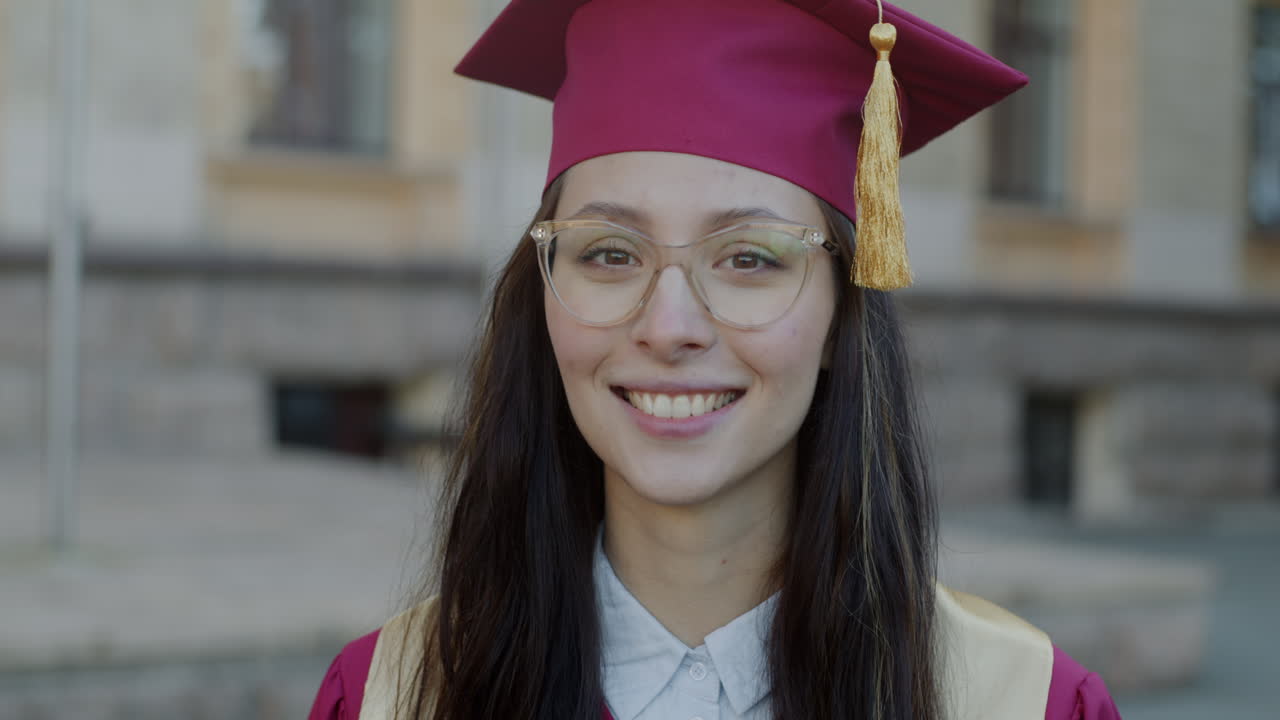 Smiling Graduate Woman in Cap and Gown