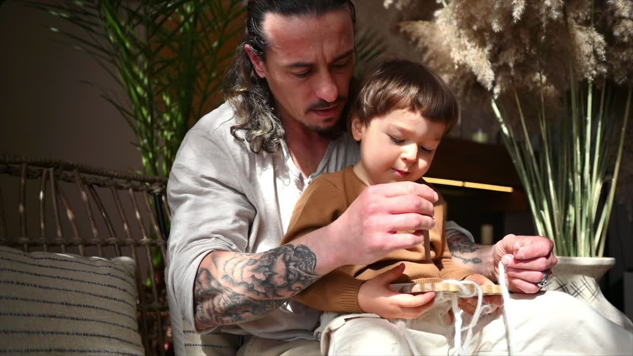 Father playing with his son with ecological wooden toys on a day bed
