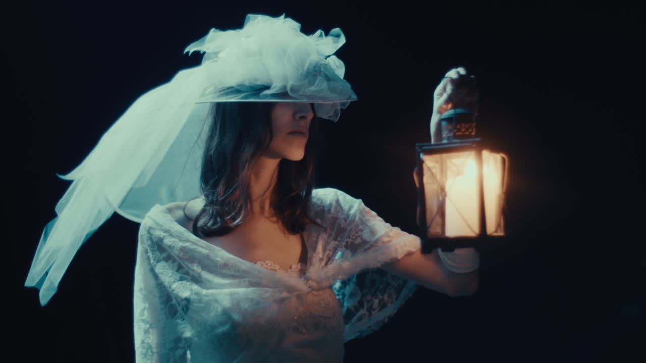 Mysterious woman in white dress holding a lantern